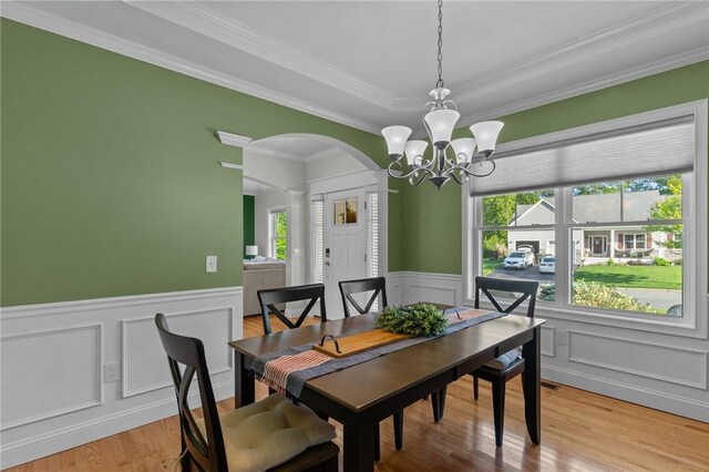 25 Ironwood Dr, Coventry, RI 02816 - dining space with arched walkways, a chandelier, a decorative wall, crown molding, and light wood finished floors