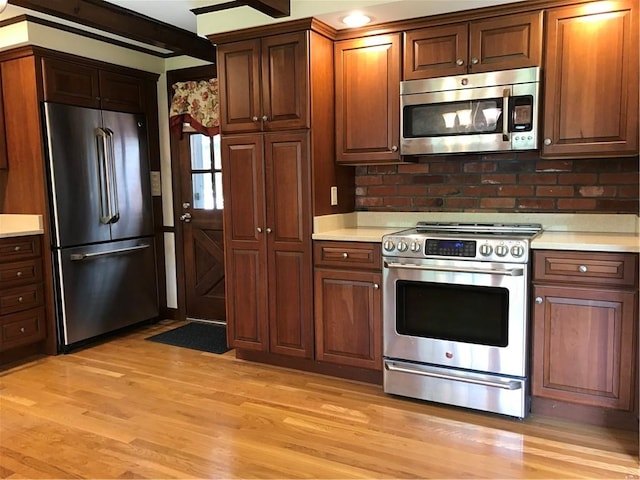 33 Red Gate Rd, Cumberland, RI 02864 - kitchen with appliances with stainless steel finishes, light countertops, light wood finished floors, and tasteful backsplash