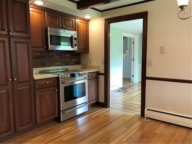 33 Red Gate Rd, Cumberland, RI 02864 - kitchen featuring appliances with stainless steel finishes, baseboard heating, light countertops, tasteful backsplash, and light wood-style flooring