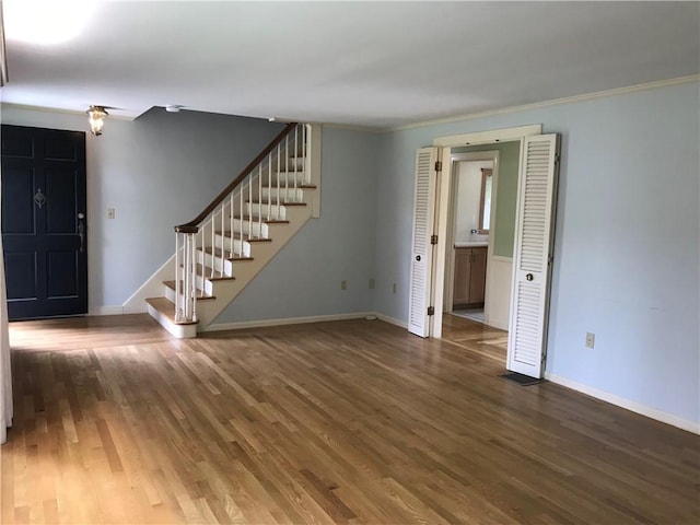 33 Red Gate Rd, Cumberland, RI 02864 - unfurnished living room with stairway, wood finished floors, baseboards, and crown molding