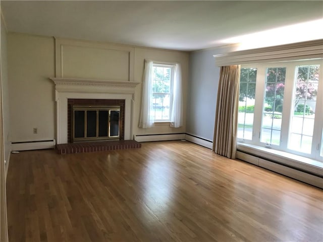 33 Red Gate Rd, Cumberland, RI 02864 - unfurnished living room with baseboard heating, wood finished floors, and a large fireplace