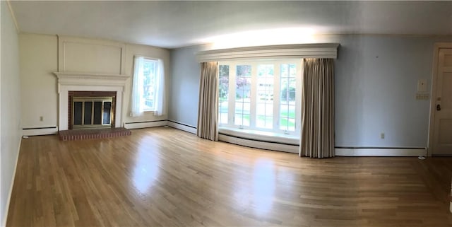 33 Red Gate Rd, Cumberland, RI 02864 - unfurnished living room featuring a baseboard heating unit, wood finished floors, a glass covered fireplace, and baseboards