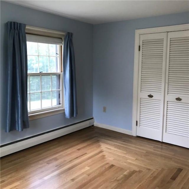 33 Red Gate Rd, Cumberland, RI 02864 - unfurnished bedroom featuring baseboard heating, a closet, and baseboards