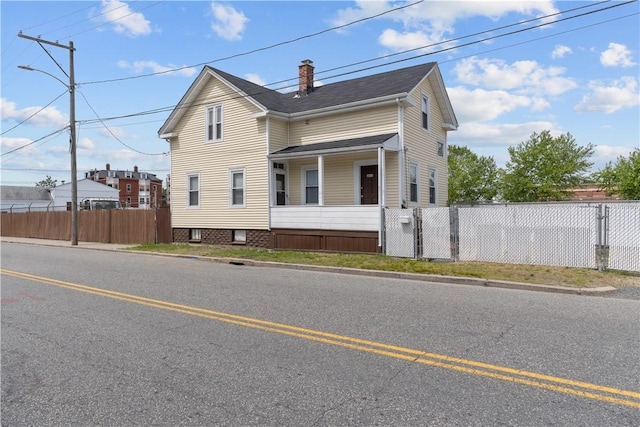 483 Dexter St, Providence, RI 02907 - view of side of property with a chimney and a gate