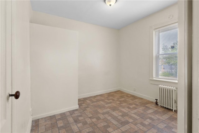 483 Dexter St, Providence, RI 02907 - unfurnished room featuring radiator, brick patterned flooring, and baseboards