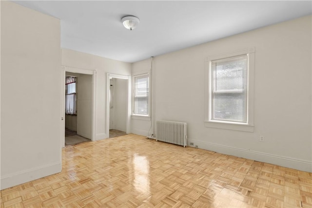 483 Dexter St, Providence, RI 02907 - unfurnished room featuring radiator, plenty of natural light, and baseboards
