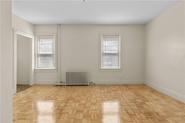 483 Dexter St, Providence, RI 02907 - empty room featuring radiator and baseboards