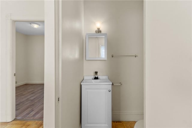 483 Dexter St, Providence, RI 02907 - bathroom featuring a sink, baseboards, and toilet