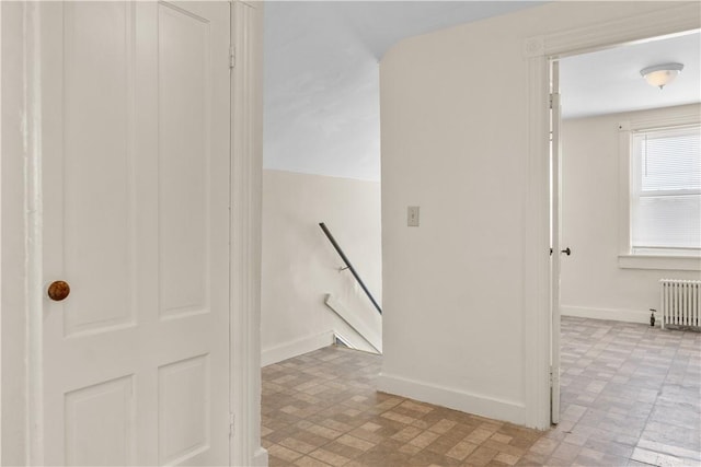 483 Dexter St, Providence, RI 02907 - hallway featuring radiator, an upstairs landing, baseboards, and brick patterned floors