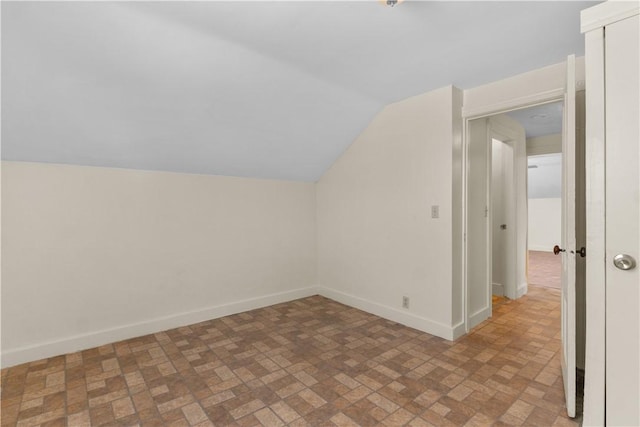 483 Dexter St, Providence, RI 02907 - bonus room with brick patterned floors, baseboards, and lofted ceiling