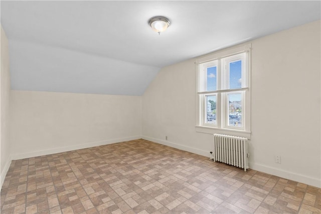 483 Dexter St, Providence, RI 02907 - bonus room featuring radiator, brick patterned floors, lofted ceiling, and baseboards