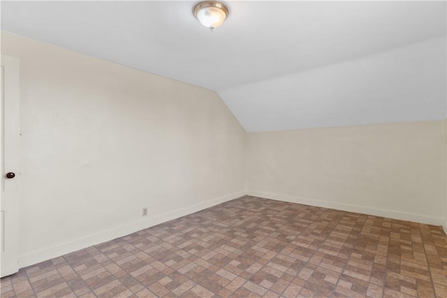 483 Dexter St, Providence, RI 02907 - bonus room featuring brick patterned floors, vaulted ceiling, and baseboards