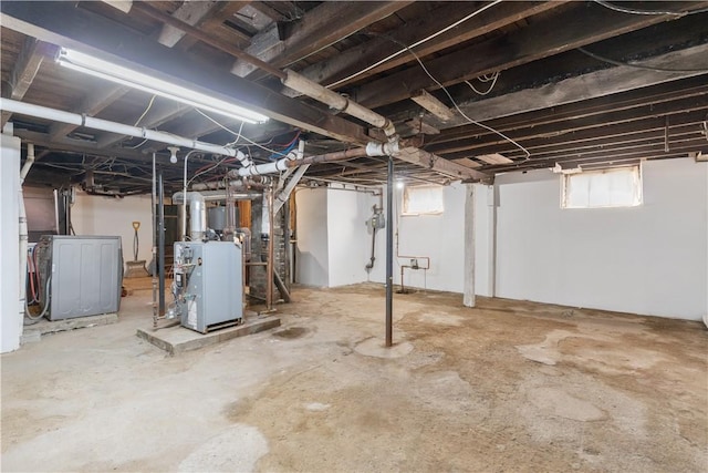 483 Dexter St, Providence, RI 02907 - below grade area featuring a heating unit, washing machine and dryer, and gas meter