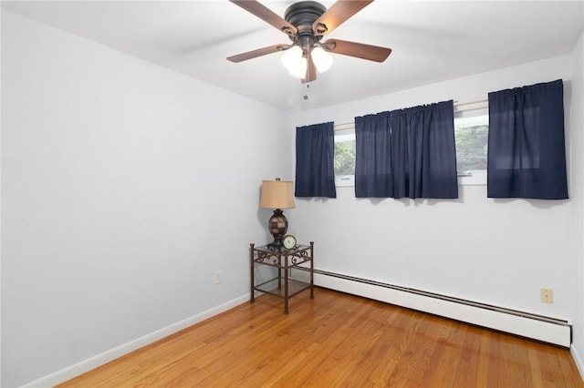 80 Flagg Ave, Warwick, RI 02886 - unfurnished room featuring a baseboard heating unit, light wood finished floors, a ceiling fan, and baseboards