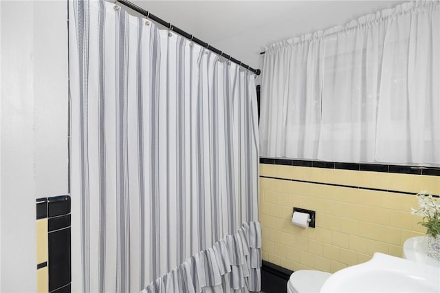 80 Flagg Ave, Warwick, RI 02886 - bathroom with toilet, tile walls, and a shower with curtain