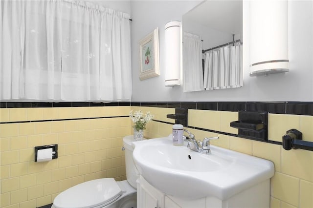 80 Flagg Ave, Warwick, RI 02886 - bathroom with tile walls, toilet, vanity, and a wainscoted wall