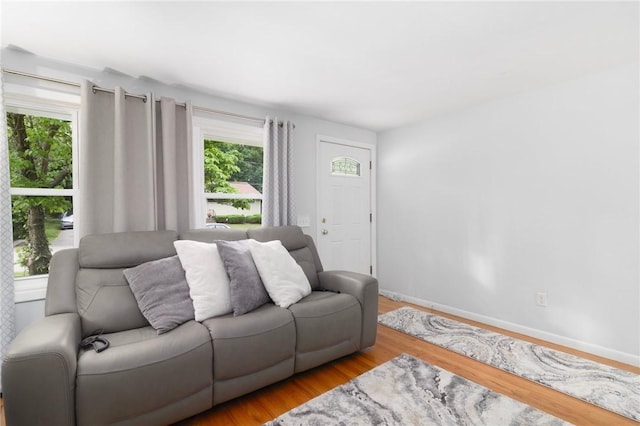 80 Flagg Ave, Warwick, RI 02886 - living area with plenty of natural light, wood finished floors, and baseboards