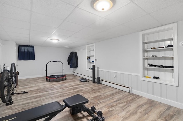 80 Flagg Ave, Warwick, RI 02886 - workout room with wood finished floors, a paneled ceiling, built in shelves, baseboard heating, and baseboards
