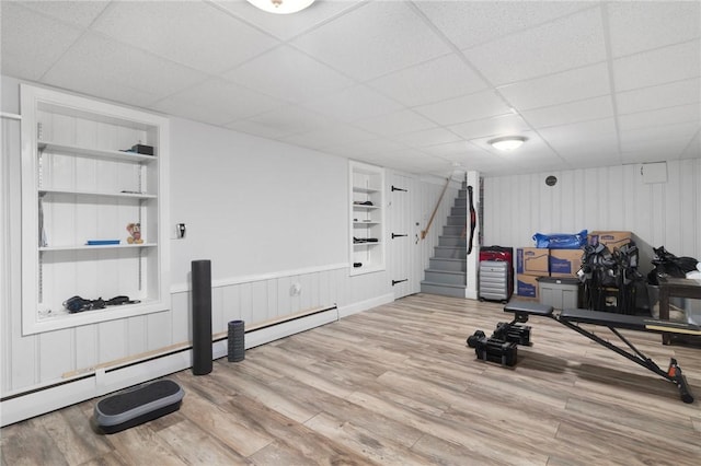80 Flagg Ave, Warwick, RI 02886 - workout room featuring built in shelves, a drop ceiling, wood finished floors, and baseboard heating