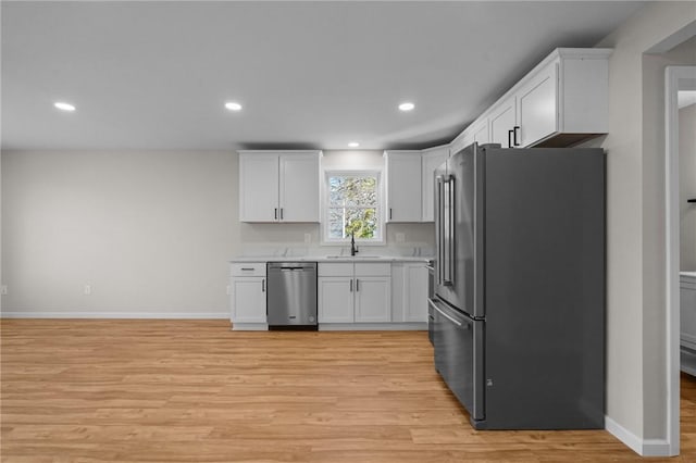 17 Judith St, Providence, RI 02909 - kitchen featuring appliances with stainless steel finishes, white cabinetry, light wood-style flooring, a sink, and recessed lighting