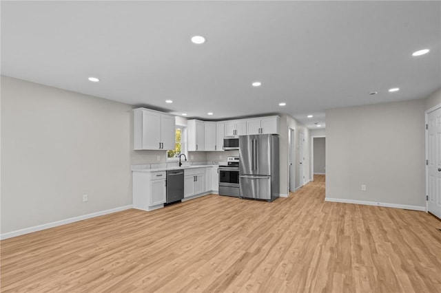 17 Judith St, Providence, RI 02909 - kitchen with stainless steel appliances, baseboards, light countertops, light wood-style flooring, and recessed lighting