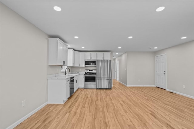 17 Judith St, Providence, RI 02909 - kitchen featuring stainless steel appliances, baseboards, a sink, light wood-style floors, and recessed lighting