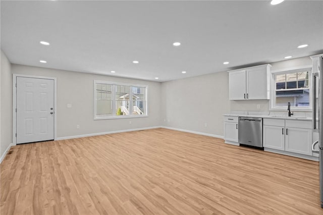 17 Judith St, Providence, RI 02909 - kitchen with dishwasher, a sink, light countertops, light wood finished floors, and recessed lighting