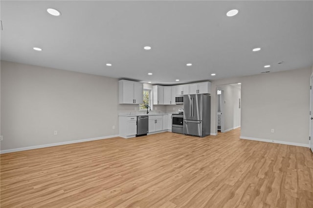 17 Judith St, Providence, RI 02909 - kitchen featuring stainless steel appliances, light countertops, baseboards, light wood-style floors, and recessed lighting