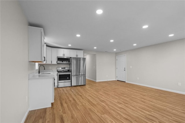17 Judith St, Providence, RI 02909 - kitchen featuring appliances with stainless steel finishes, light countertops, baseboards, recessed lighting, and light wood-style floors