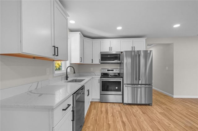 17 Judith St, Providence, RI 02909 - kitchen with stainless steel appliances, a sink, light stone countertops, white cabinets, and recessed lighting