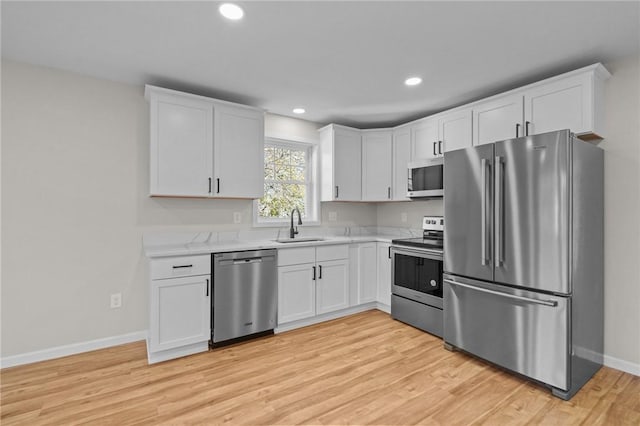 17 Judith St, Providence, RI 02909 - kitchen featuring appliances with stainless steel finishes, a sink, baseboards, white cabinets, and recessed lighting