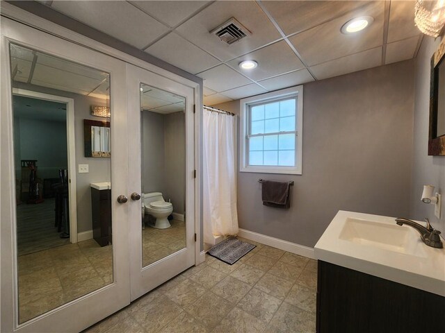 49 Wine St, Cranston, RI 02920 - bathroom with toilet, baseboards, vanity, and a paneled ceiling