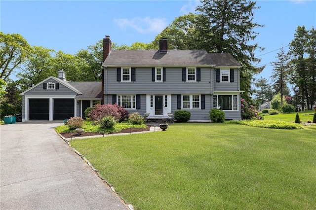 2 Carvin Ct, Warwick, RI 02886 - colonial inspired home featuring a front yard, a garage, asphalt driveway, and a chimney