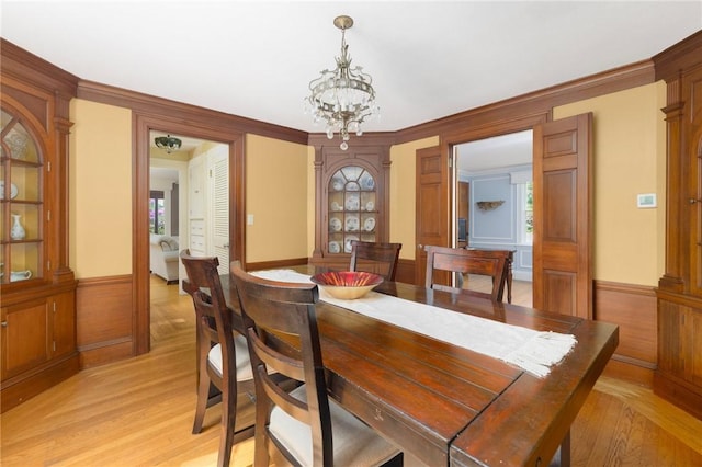 2 Carvin Ct, Warwick, RI 02886 - dining area featuring a chandelier, wainscoting, light wood finished floors, and ornamental molding