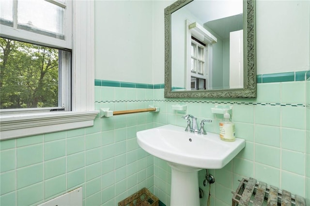 2 Carvin Ct, Warwick, RI 02886 - bathroom featuring radiator, tile walls, healthy amount of natural light, and a wainscoted wall