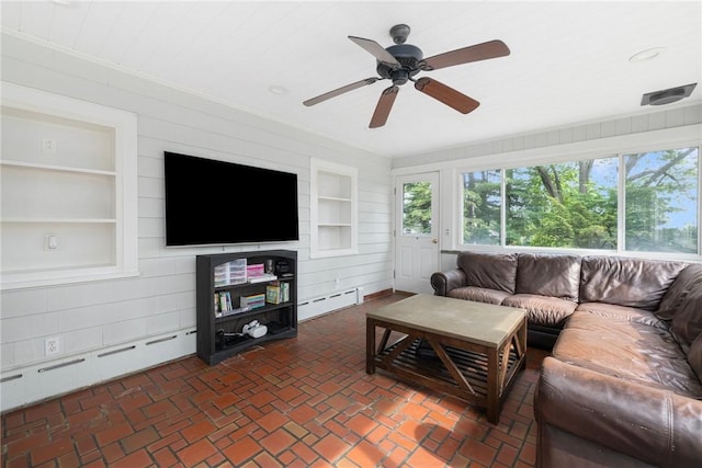 2 Carvin Ct, Warwick, RI 02886 - living area featuring a baseboard heating unit, built in features, a ceiling fan, and wooden walls