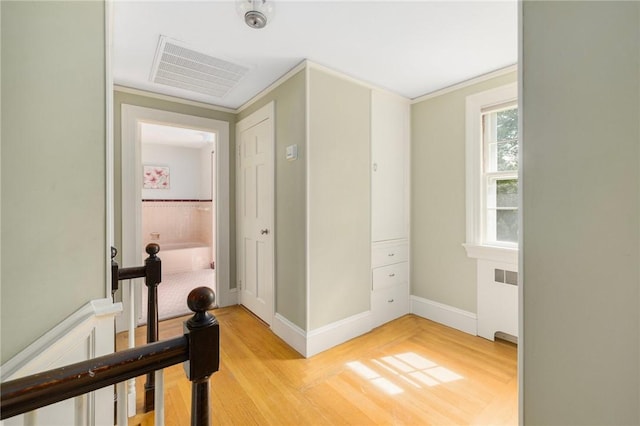 2 Carvin Ct, Warwick, RI 02886 - hallway with radiator, light wood-type flooring, and baseboards