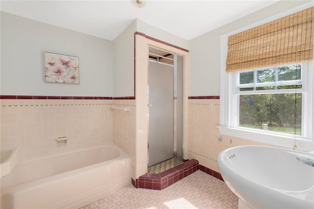 2 Carvin Ct, Warwick, RI 02886 - full bathroom with a bath, a shower stall, a wainscoted wall, and tile walls