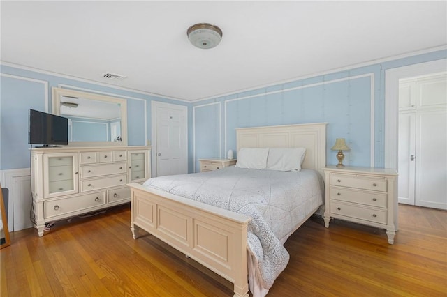 2 Carvin Ct, Warwick, RI 02886 - bedroom with a decorative wall and dark wood-style floors