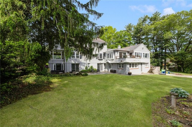 2 Carvin Ct, Warwick, RI 02886 - back of property featuring a lawn and cooling unit