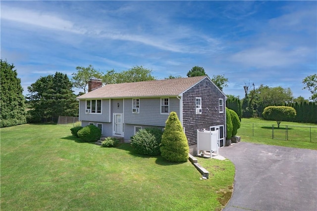 37 Seabreeze Ter, South Kingstown, RI 02879 - raised ranch featuring asphalt driveway, a chimney, and a garage