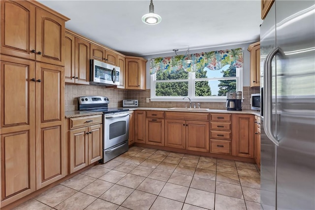 37 Seabreeze Ter, South Kingstown, RI 02879 - kitchen featuring stainless steel appliances, a sink, brown cabinetry, and backsplash
