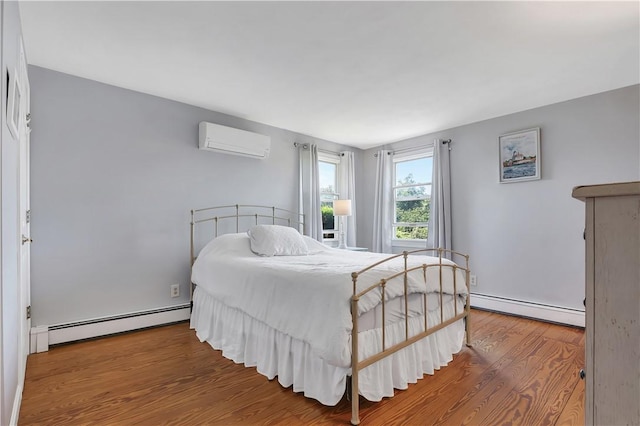 37 Seabreeze Ter, South Kingstown, RI 02879 - bedroom featuring a baseboard radiator, a wall unit AC, wood finished floors, and baseboards