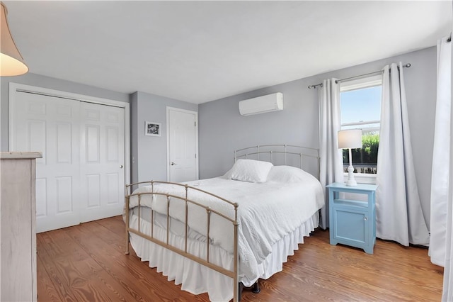 37 Seabreeze Ter, South Kingstown, RI 02879 - bedroom with wood finished floors, a wall mounted AC, and a closet