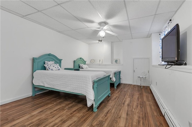 37 Seabreeze Ter, South Kingstown, RI 02879 - bedroom featuring a baseboard radiator, a drop ceiling, dark wood-type flooring, a ceiling fan, and baseboards