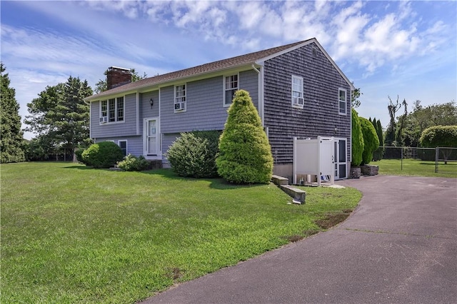37 Seabreeze Ter, South Kingstown, RI 02879 - view of side of property with a chimney and asphalt driveway
