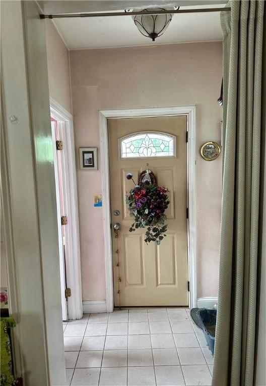 53 Wampanoag Trl, East Providence, RI 02915 - entrance foyer with light tile patterned floors and baseboards