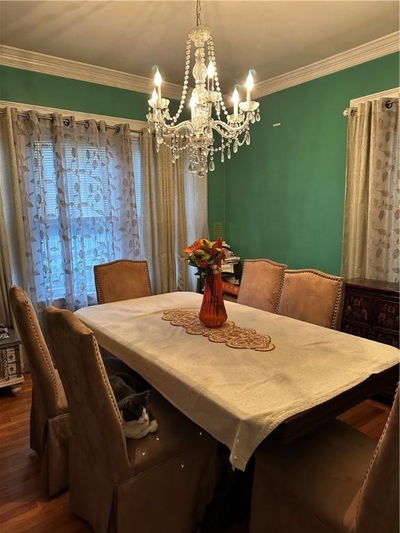 53 Wampanoag Trl, East Providence, RI 02915 - dining room featuring a chandelier, dark wood-style flooring, and crown molding