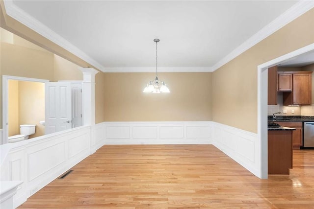 156 Hampton Way S, Kingstown, RI 02879 - unfurnished dining area with light wood-style flooring, ornamental molding, a chandelier, and wainscoting