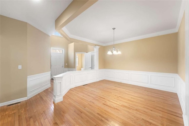 156 Hampton Way S, Kingstown, RI 02879 - spare room featuring a chandelier, light wood-style flooring, wainscoting, a decorative wall, and ornamental molding